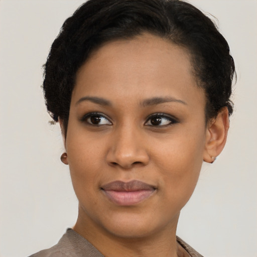Joyful black young-adult female with short  brown hair and brown eyes