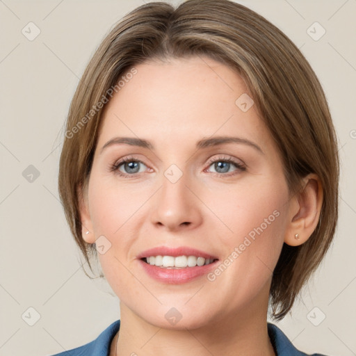 Joyful white young-adult female with medium  brown hair and grey eyes