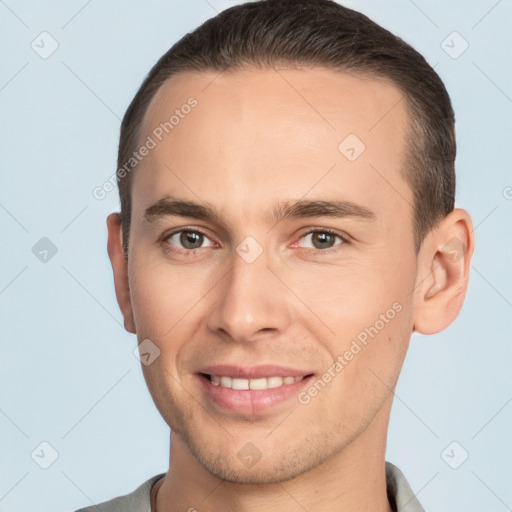 Joyful white young-adult male with short  brown hair and brown eyes