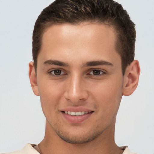 Joyful white young-adult male with short  brown hair and brown eyes