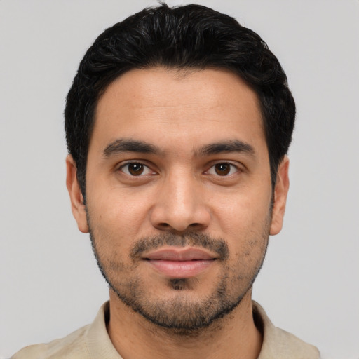Joyful latino young-adult male with short  black hair and brown eyes