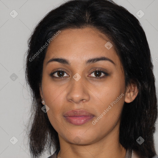 Joyful latino young-adult female with long  brown hair and brown eyes