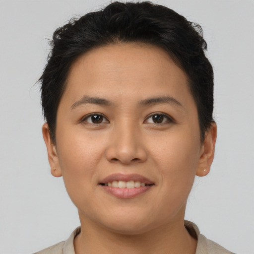 Joyful asian young-adult female with short  brown hair and brown eyes