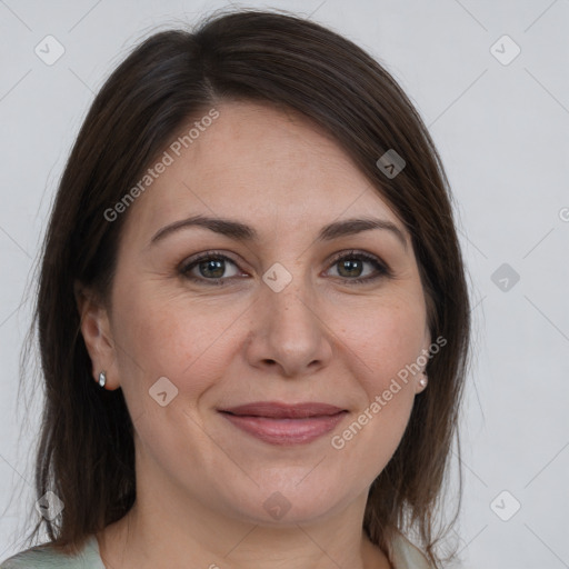 Joyful white adult female with medium  brown hair and brown eyes