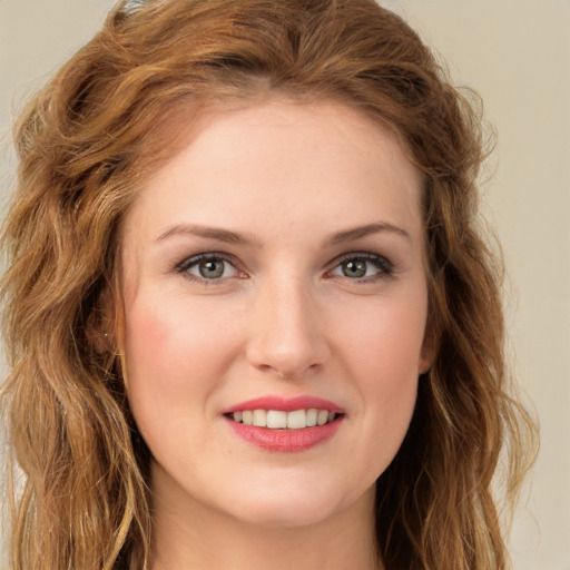 Joyful white young-adult female with long  brown hair and green eyes