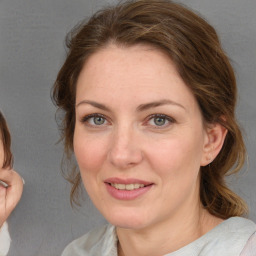 Joyful white young-adult female with medium  brown hair and grey eyes