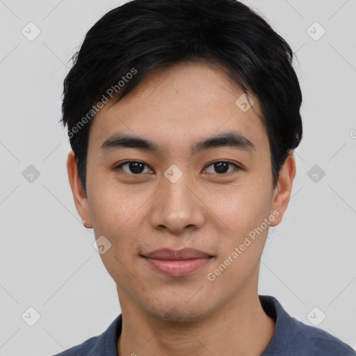 Joyful asian young-adult male with short  black hair and brown eyes