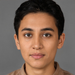 Joyful latino young-adult male with short  brown hair and brown eyes