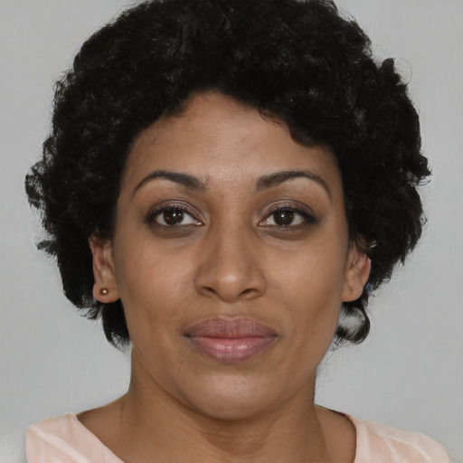 Joyful black adult female with short  brown hair and brown eyes