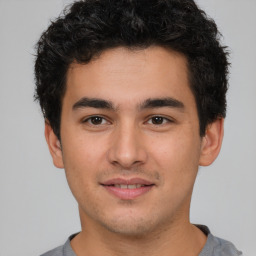 Joyful latino young-adult male with short  brown hair and brown eyes