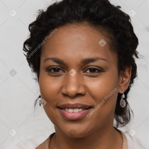 Joyful black young-adult female with long  brown hair and brown eyes