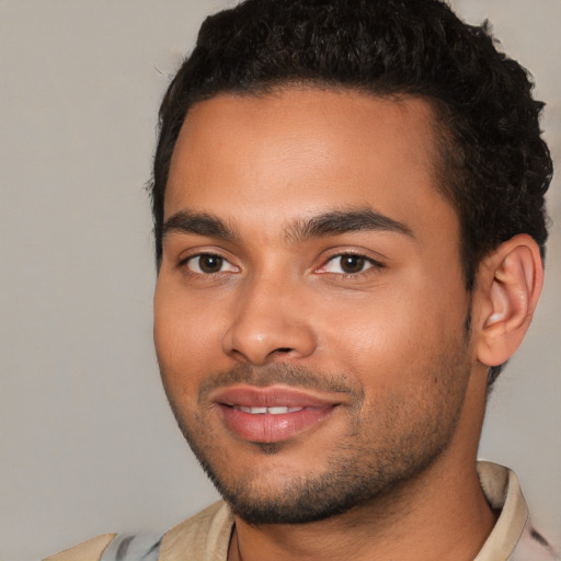 Joyful white young-adult male with short  black hair and brown eyes