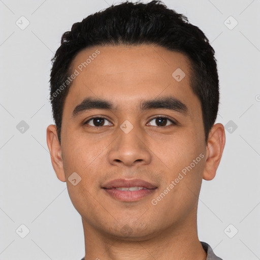 Joyful latino young-adult male with short  black hair and brown eyes