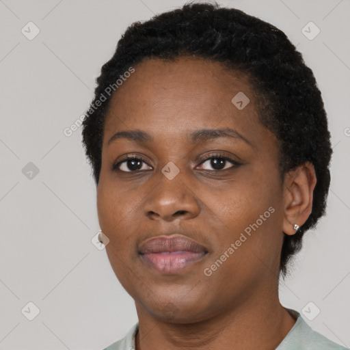 Joyful black young-adult female with short  black hair and brown eyes