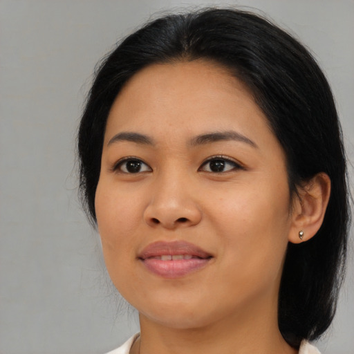 Joyful asian young-adult female with medium  black hair and brown eyes