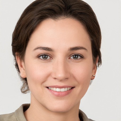 Joyful white young-adult female with medium  brown hair and grey eyes