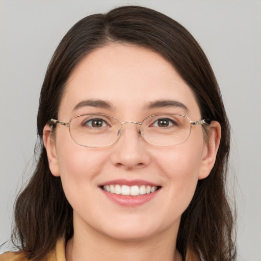 Joyful white young-adult female with medium  brown hair and grey eyes