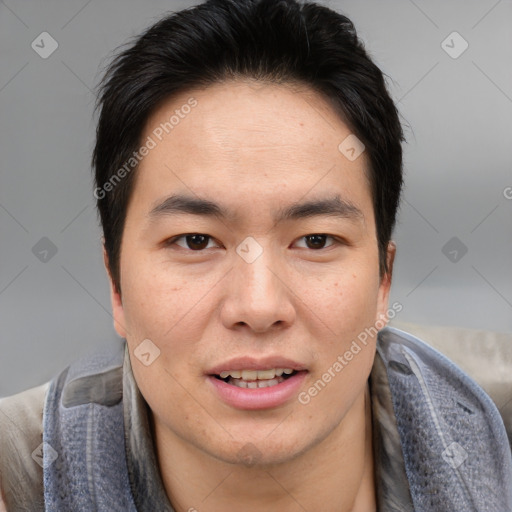 Joyful asian young-adult male with short  brown hair and brown eyes