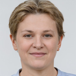 Joyful white adult female with short  brown hair and grey eyes