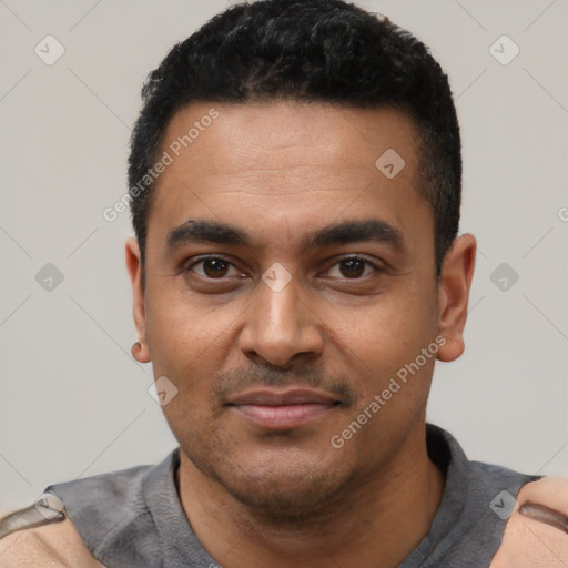 Joyful latino young-adult male with short  black hair and brown eyes