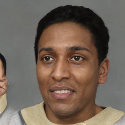 Joyful latino young-adult male with short  black hair and brown eyes