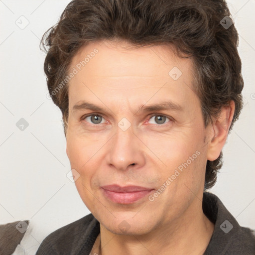 Joyful white adult male with short  brown hair and grey eyes