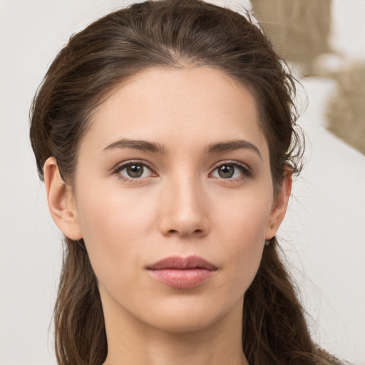 Neutral white young-adult female with long  brown hair and brown eyes