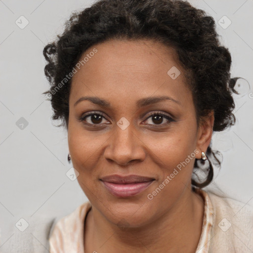 Joyful black adult female with short  brown hair and brown eyes