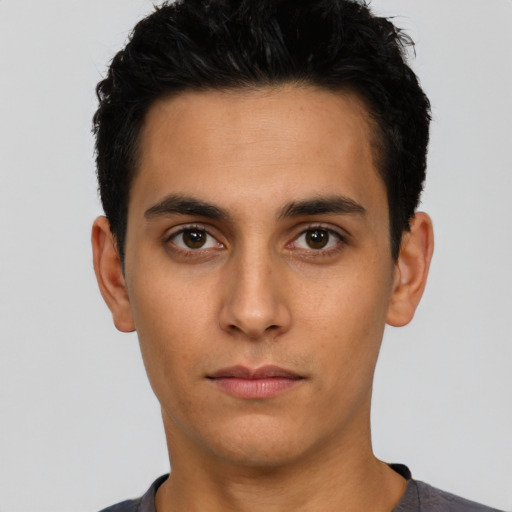 Neutral latino young-adult male with short  black hair and brown eyes