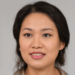 Joyful asian young-adult female with medium  brown hair and brown eyes