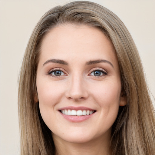 Joyful white young-adult female with long  brown hair and grey eyes