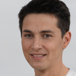 Joyful white adult male with short  brown hair and brown eyes