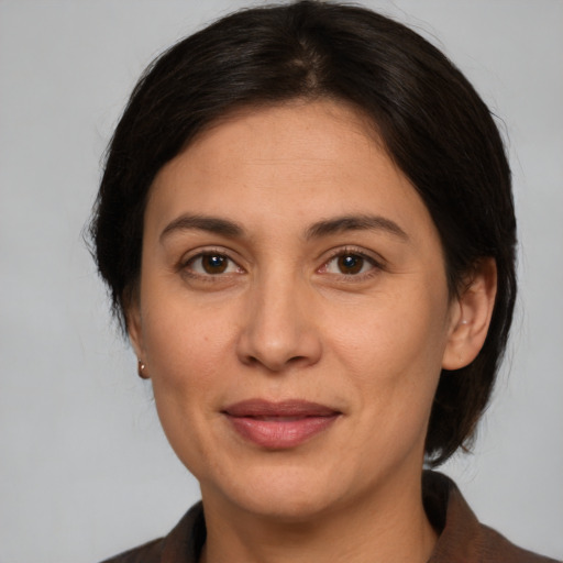 Joyful white adult female with medium  brown hair and brown eyes