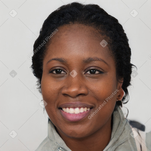 Joyful black young-adult female with long  black hair and brown eyes