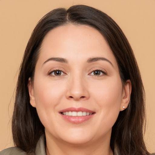 Joyful white young-adult female with long  brown hair and brown eyes