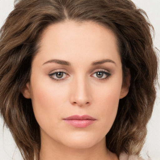 Joyful white young-adult female with long  brown hair and green eyes