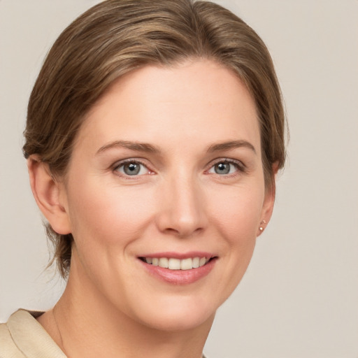 Joyful white young-adult female with medium  brown hair and grey eyes