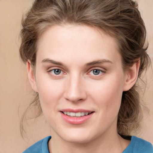 Joyful white young-adult female with medium  brown hair and blue eyes