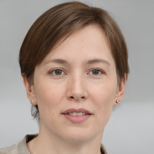 Joyful white young-adult female with medium  brown hair and grey eyes