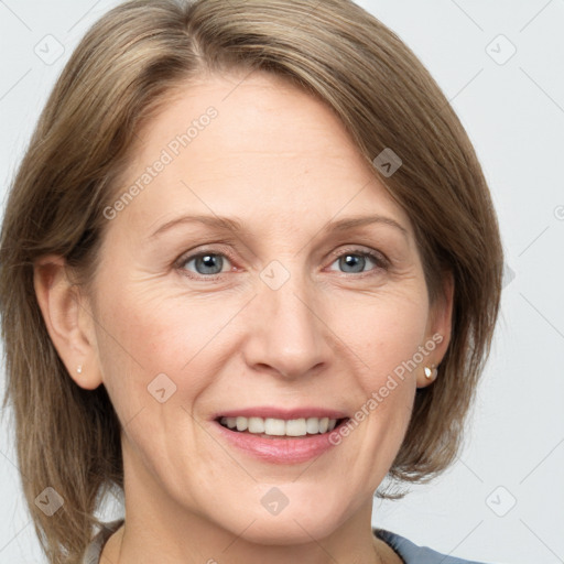 Joyful white adult female with medium  brown hair and grey eyes