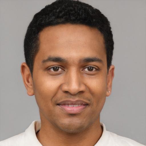 Joyful latino young-adult male with short  black hair and brown eyes