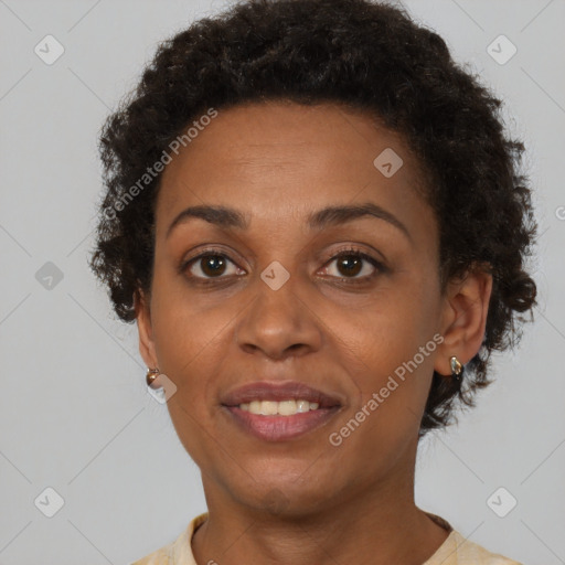 Joyful black adult female with short  brown hair and brown eyes