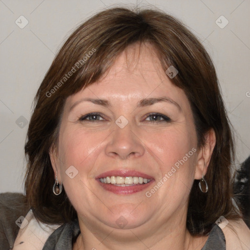 Joyful white adult female with medium  brown hair and blue eyes