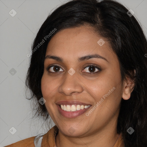 Joyful latino young-adult female with long  black hair and brown eyes