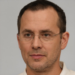 Joyful white adult male with short  brown hair and brown eyes