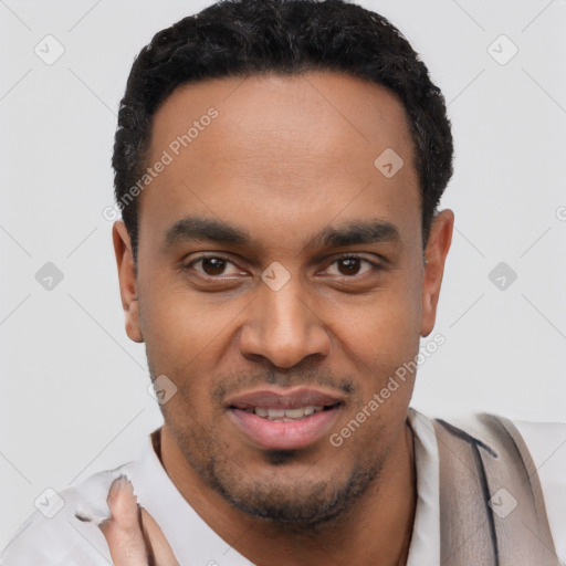 Joyful latino young-adult male with short  black hair and brown eyes