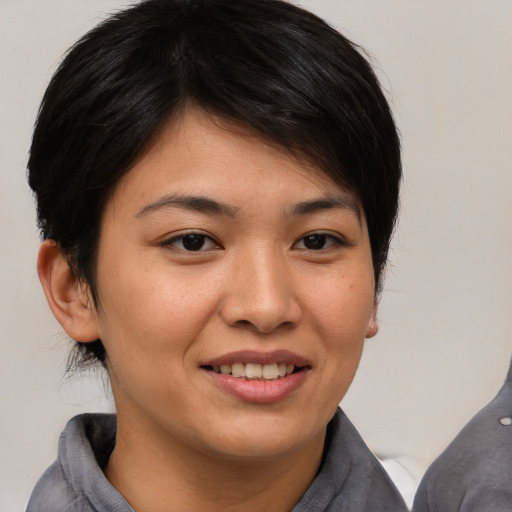 Joyful asian young-adult female with medium  brown hair and brown eyes