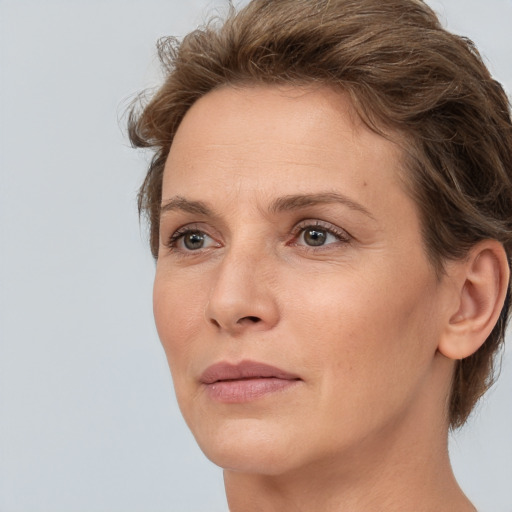 Joyful white adult female with short  brown hair and brown eyes