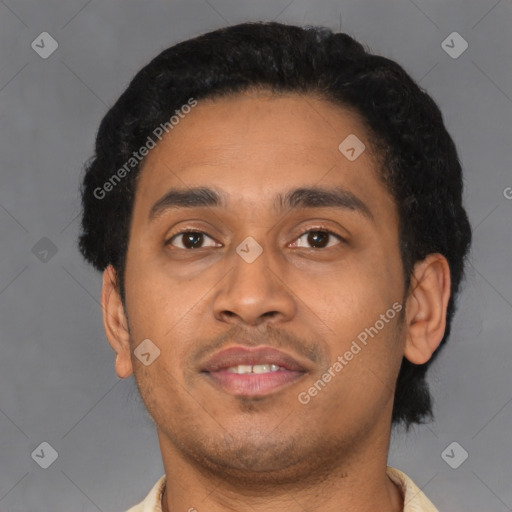Joyful latino young-adult male with short  black hair and brown eyes