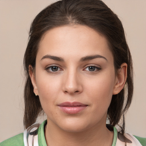 Joyful white young-adult female with medium  brown hair and brown eyes